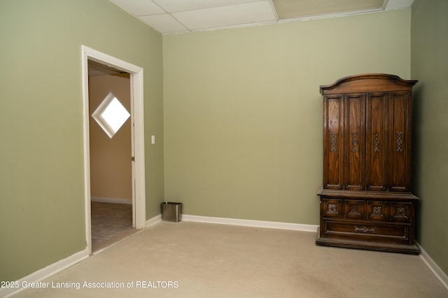 unfurnished bedroom featuring light colored carpet and baseboards