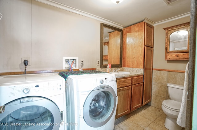 2820 N Lima Center Rd, Dexter, MI 48130 - clothes washing area featuring a sink, tile walls, laundry area, light tile patterned flooring, and washing machine and clothes dryer