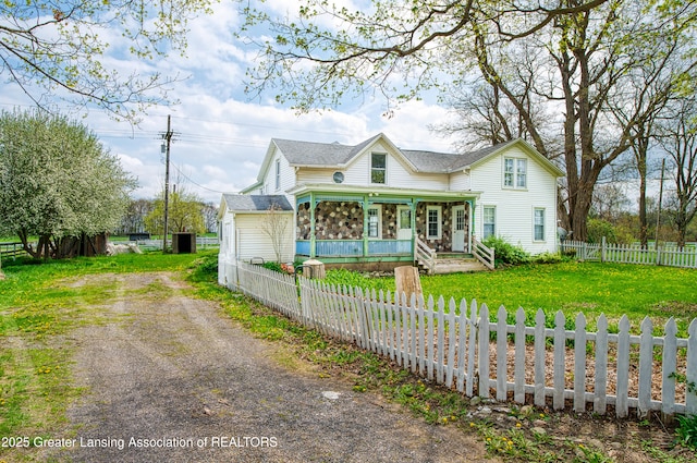 2820 N Lima Center Rd, Dexter, MI 48130 - view of front facade with driveway, a fenced front yard, covered porch, a shingled roof, and a front yard