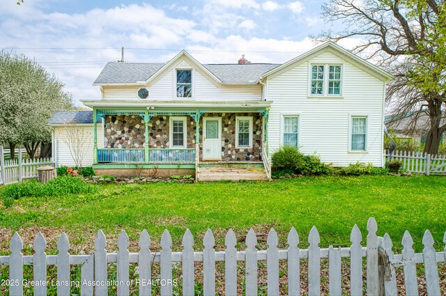 2820 N Lima Center Rd, Dexter, MI 48130 - view of front of house with covered porch, a fenced front yard, and a front lawn