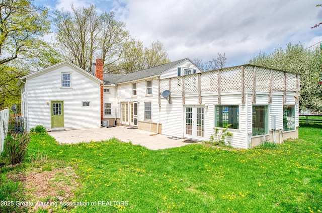 2820 N Lima Center Rd, Dexter, MI 48130 - back of property with a yard, a patio area, french doors, and a chimney