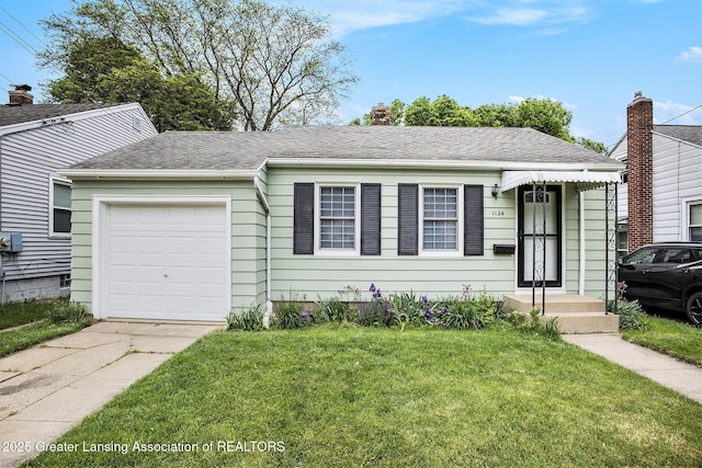 1124 Poxson Ave, Lansing, MI 48910 - view of front of house with concrete driveway, a front lawn, an attached garage, and a shingled roof