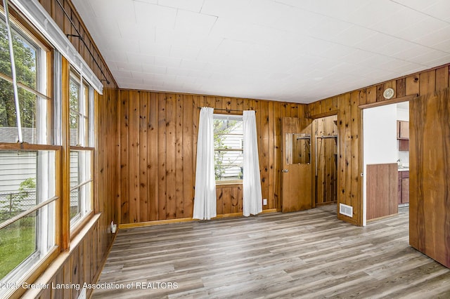 1124 Poxson Ave, Lansing, MI 48910 - spare room featuring wood finished floors and wooden walls