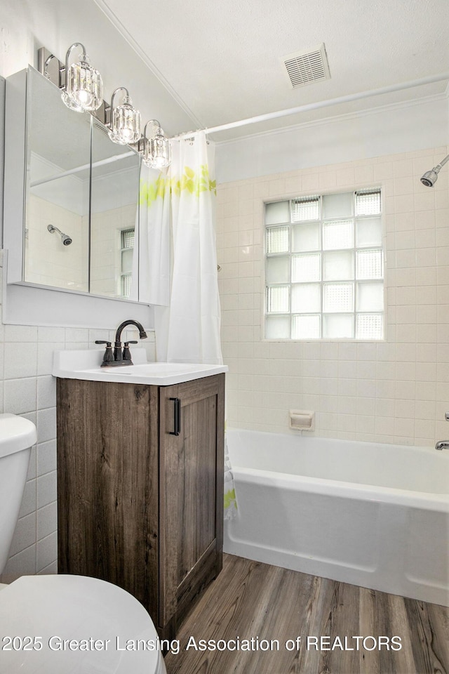 1124 Poxson Ave, Lansing, MI 48910 - bathroom featuring toilet, crown molding, wood finished floors, shower / tub combo with curtain, and vanity
