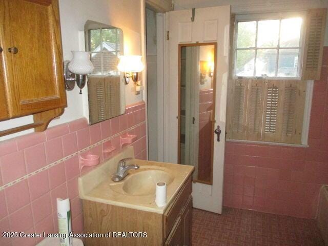 bathroom featuring tile walls and vanity