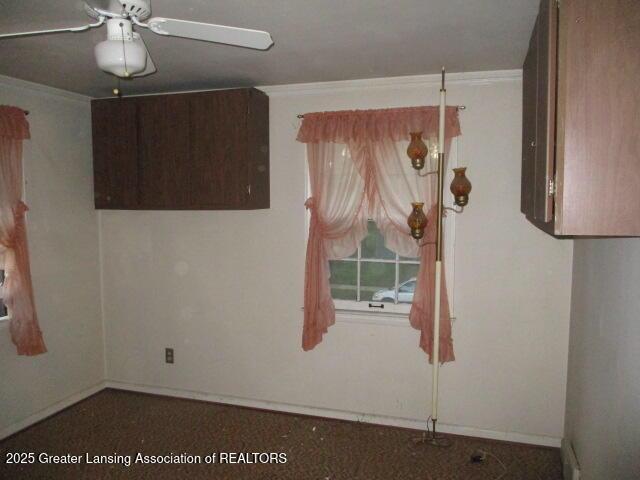 unfurnished room with ceiling fan, crown molding, and baseboards