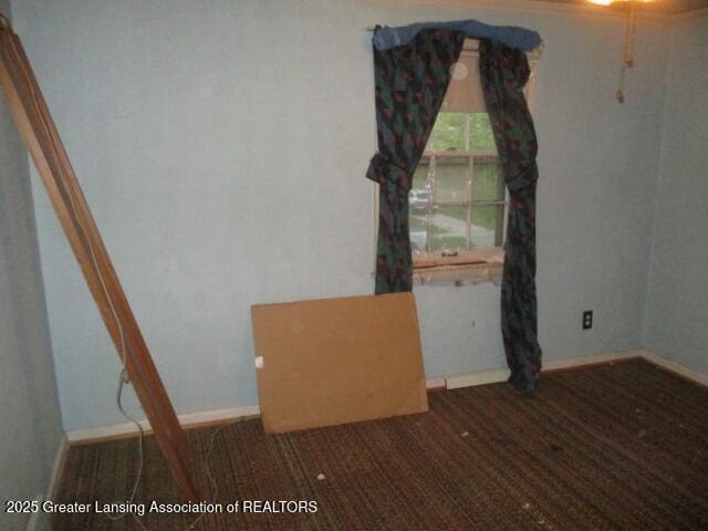 spare room with baseboards