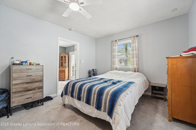 bedroom with carpet flooring, ceiling fan, baseboards, and a textured ceiling
