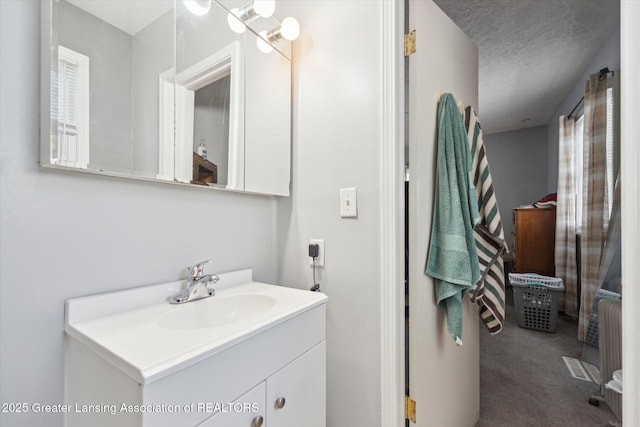 bathroom with vanity and a textured ceiling