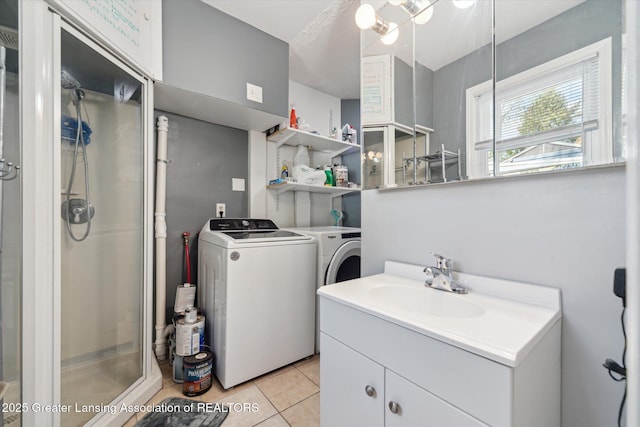 clothes washing area with separate washer and dryer and light tile patterned floors