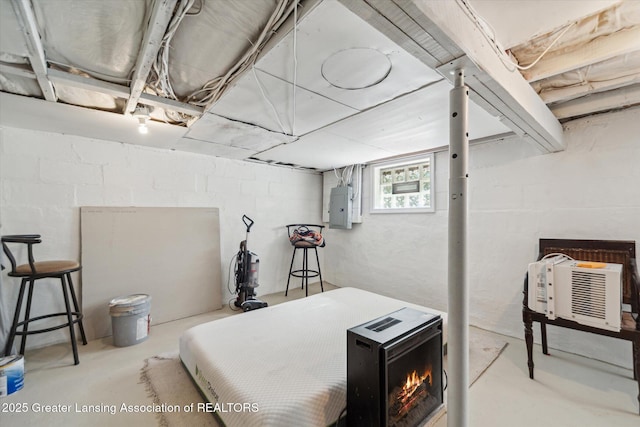 bedroom featuring electric panel and concrete floors