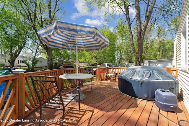 wooden terrace with outdoor dining space and area for grilling
