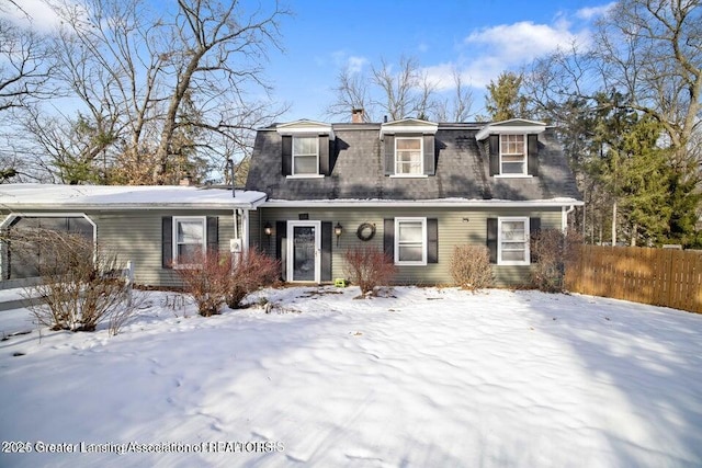 view of front of home featuring fence and a chimney