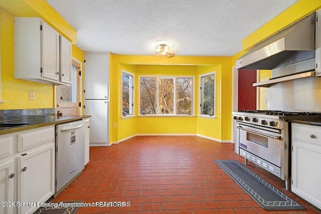 kitchen with appliances with stainless steel finishes, under cabinet range hood, baseboards, white cabinetry, and brick flooring