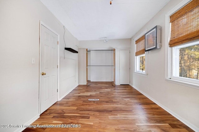unfurnished bedroom featuring light wood-type flooring and baseboards