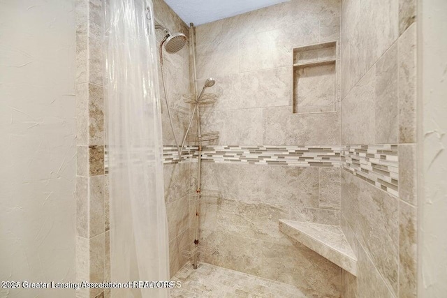 bathroom with tiled shower