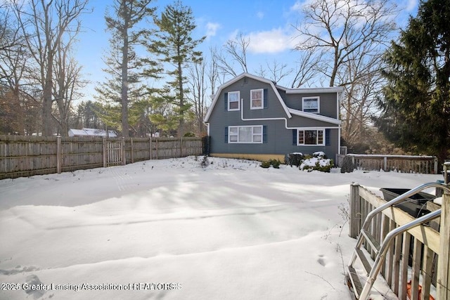 view of snowy exterior featuring fence