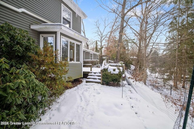 snow covered property featuring a deck