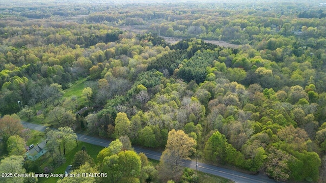 view of property location featuring a forest