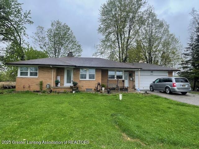 6422 E Saginaw Hwy, Grand Ledge, MI 48837 - ranch-style home with an attached garage, a chimney, a front yard, and asphalt driveway