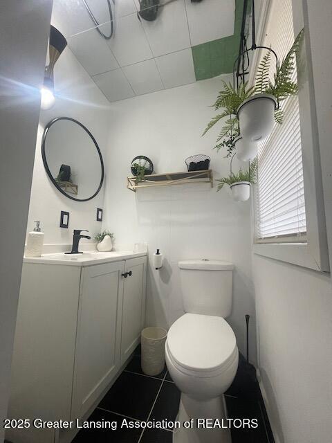 6422 E Saginaw Hwy, Grand Ledge, MI 48837 - bathroom featuring vanity, toilet, and tile patterned flooring