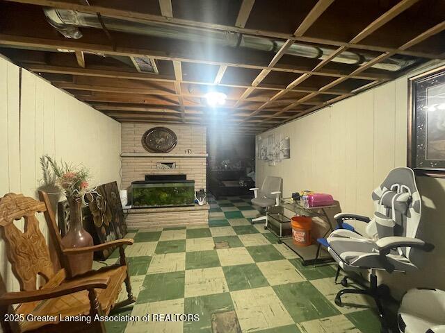 6422 E Saginaw Hwy, Grand Ledge, MI 48837 - finished basement with tile patterned floors and a brick fireplace