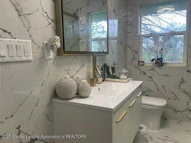 6422 E Saginaw Hwy, Grand Ledge, MI 48837 - bathroom featuring toilet, vanity, and marble tiled floors
