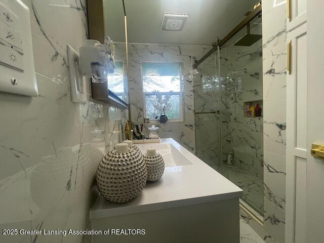 6422 E Saginaw Hwy, Grand Ledge, MI 48837 - full bathroom featuring a marble finish shower, marble finish floors, and vanity