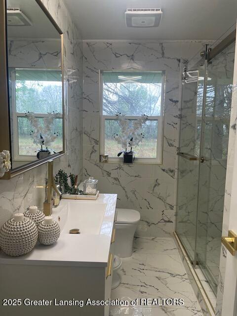 6422 E Saginaw Hwy, Grand Ledge, MI 48837 - bathroom with a marble finish shower, vanity, marble tiled floors, and toilet