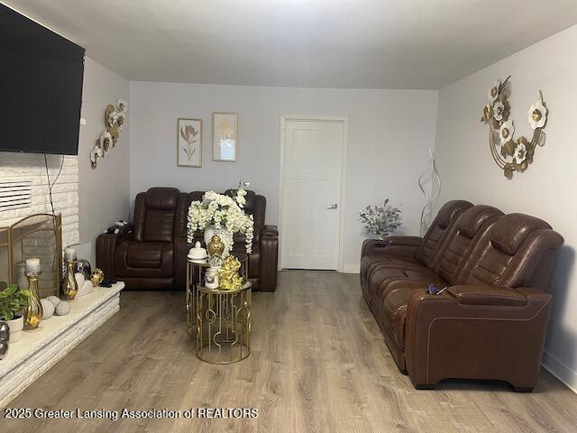 6422 E Saginaw Hwy, Grand Ledge, MI 48837 - living area with wood finished floors and a fireplace with raised hearth