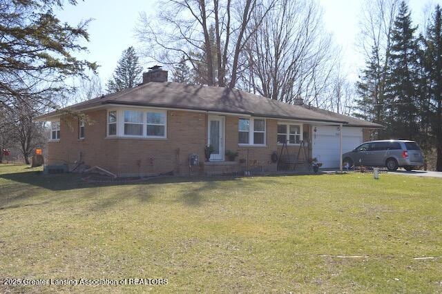6422 E Saginaw Hwy, Grand Ledge, MI 48837 - ranch-style home with a garage, a chimney, a front lawn, and brick siding