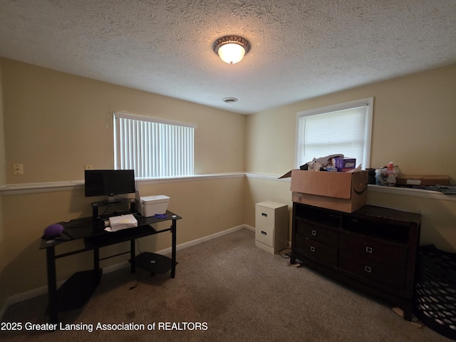 office with carpet floors and a textured ceiling