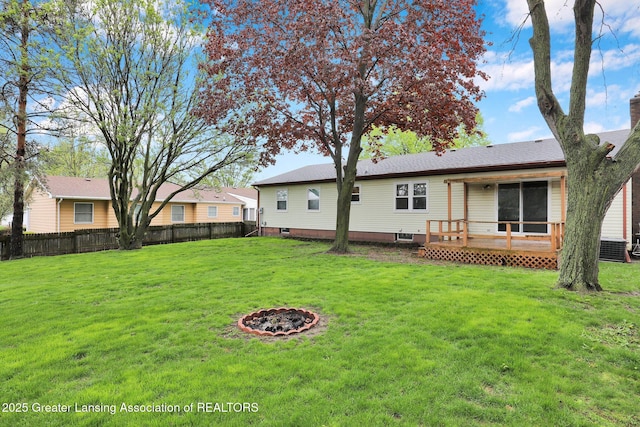 910 Pecos Dr, Lansing, MI 48917 - back of property featuring a deck and a fire pit