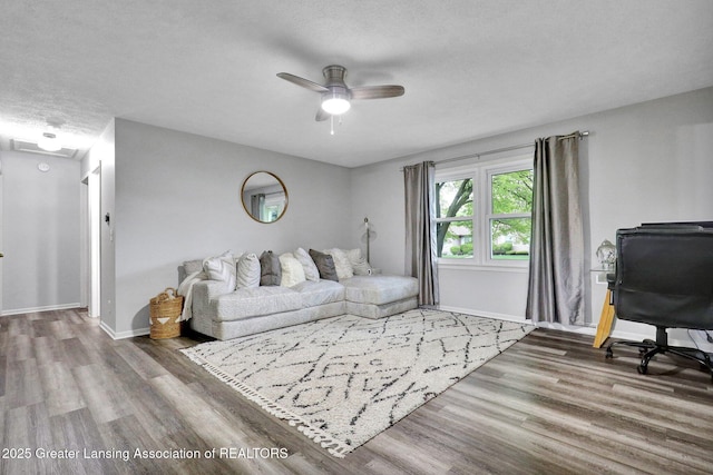 910 Pecos Dr, Lansing, MI 48917 - living room with wood finished floors, ceiling fan, and baseboards