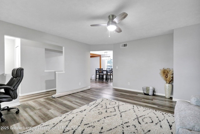 910 Pecos Dr, Lansing, MI 48917 - office space with a ceiling fan, wood finished floors, and baseboards