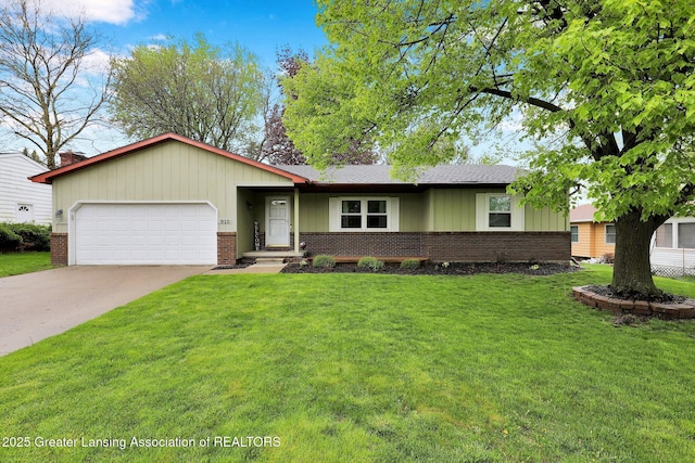 910 Pecos Dr, Lansing, MI 48917 - ranch-style house with brick siding, an attached garage, concrete driveway, and a front lawn