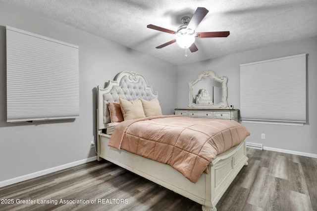 910 Pecos Dr, Lansing, MI 48917 - bedroom featuring wood finished floors, a textured ceiling, baseboards, and a ceiling fan