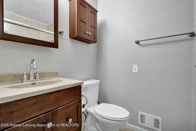 910 Pecos Dr, Lansing, MI 48917 - bathroom featuring toilet, vanity, and baseboards