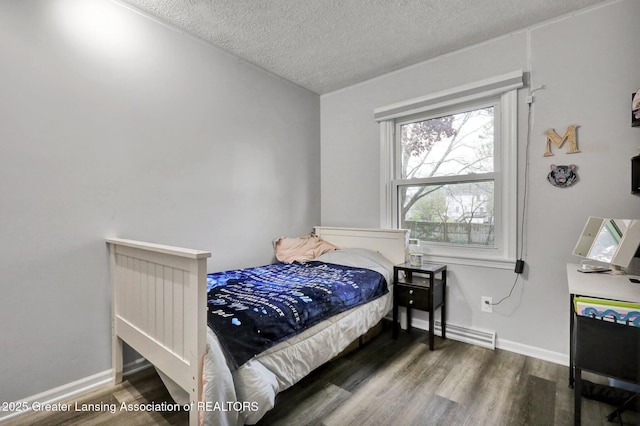 910 Pecos Dr, Lansing, MI 48917 - bedroom featuring a textured ceiling, wood finished floors, and baseboards