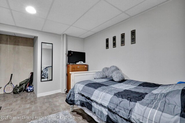 910 Pecos Dr, Lansing, MI 48917 - bedroom featuring a drop ceiling and baseboards