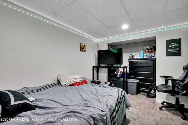 910 Pecos Dr, Lansing, MI 48917 - bedroom featuring a paneled ceiling, baseboards, and recessed lighting