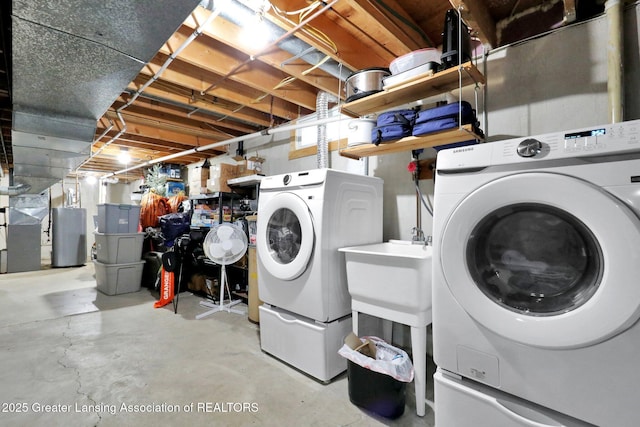 910 Pecos Dr, Lansing, MI 48917 - laundry room with washer and clothes dryer and water heater