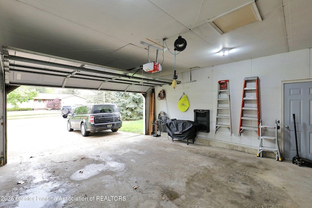910 Pecos Dr, Lansing, MI 48917 - garage featuring a garage door opener