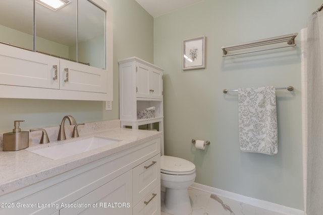 bathroom featuring toilet, baseboards, marble look tile flooring, and vanity