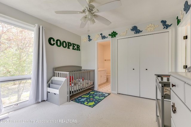 carpeted bedroom featuring a closet and ceiling fan