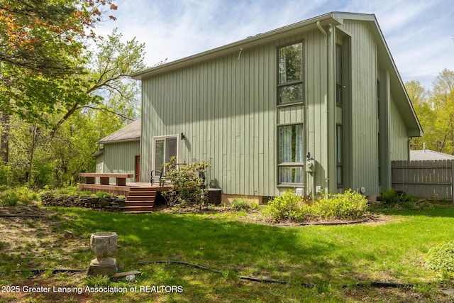 view of home's exterior with a wooden deck