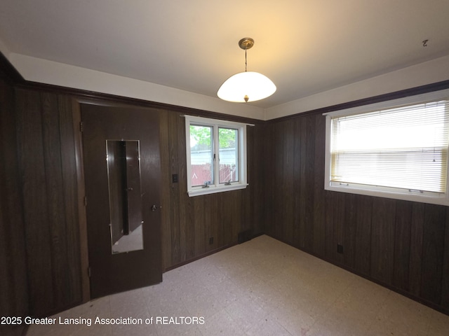 526 Fenton St, Lansing, MI 48910 - spare room featuring light floors and wooden walls