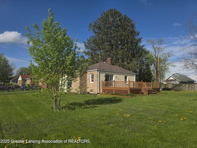 back of house with a wooden deck and a chimney