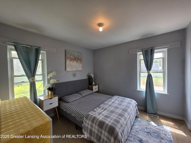 carpeted bedroom featuring baseboards