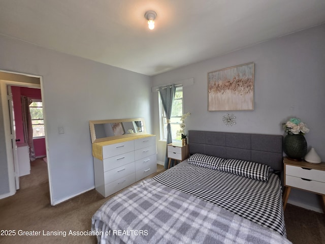 bedroom featuring carpet flooring and baseboards